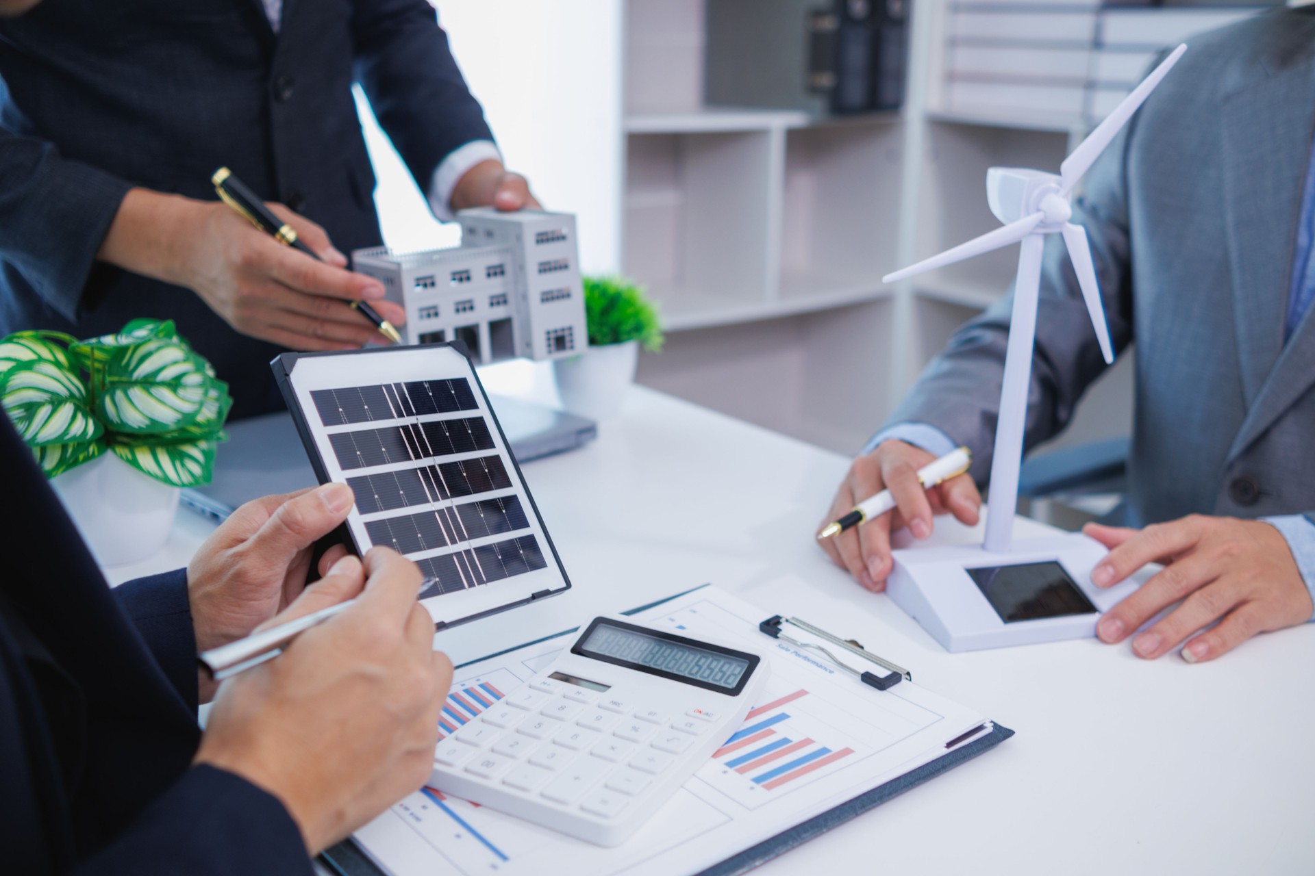 architects and investors discuss real estate projects using clean energy or solar cells within residential construction projects. Concept using clean energy in large residential construction projects.
